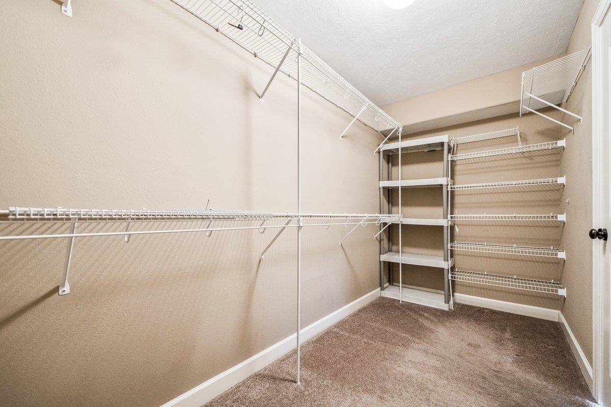583 Rosemark Road Atoka, TN 38004 - Photo 17 of 25 a view of walk in closet with empty racks