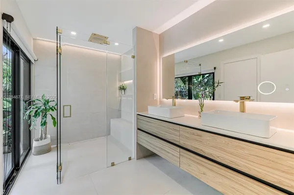 a bathroom with a double vanity sink and a bathtub