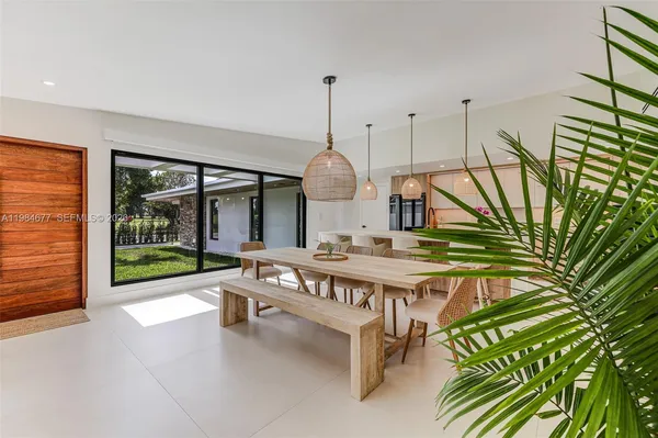 a living room with furniture a rug and white walls