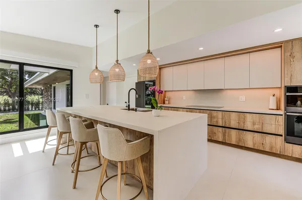 a kitchen with a table chairs and refrigerator
