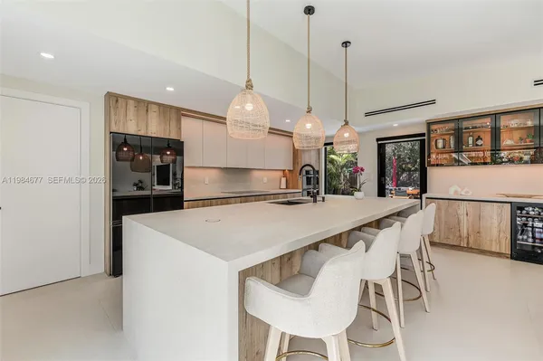 a large kitchen with a table and chairs