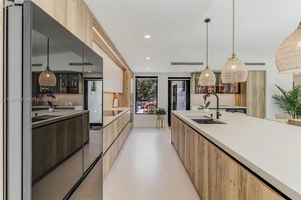 a large kitchen with kitchen island a large counter space a sink and cabinets
