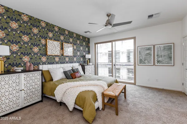 a bedroom with a bed and a large window