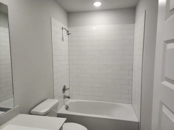 a bathroom with a bathtub and a shower