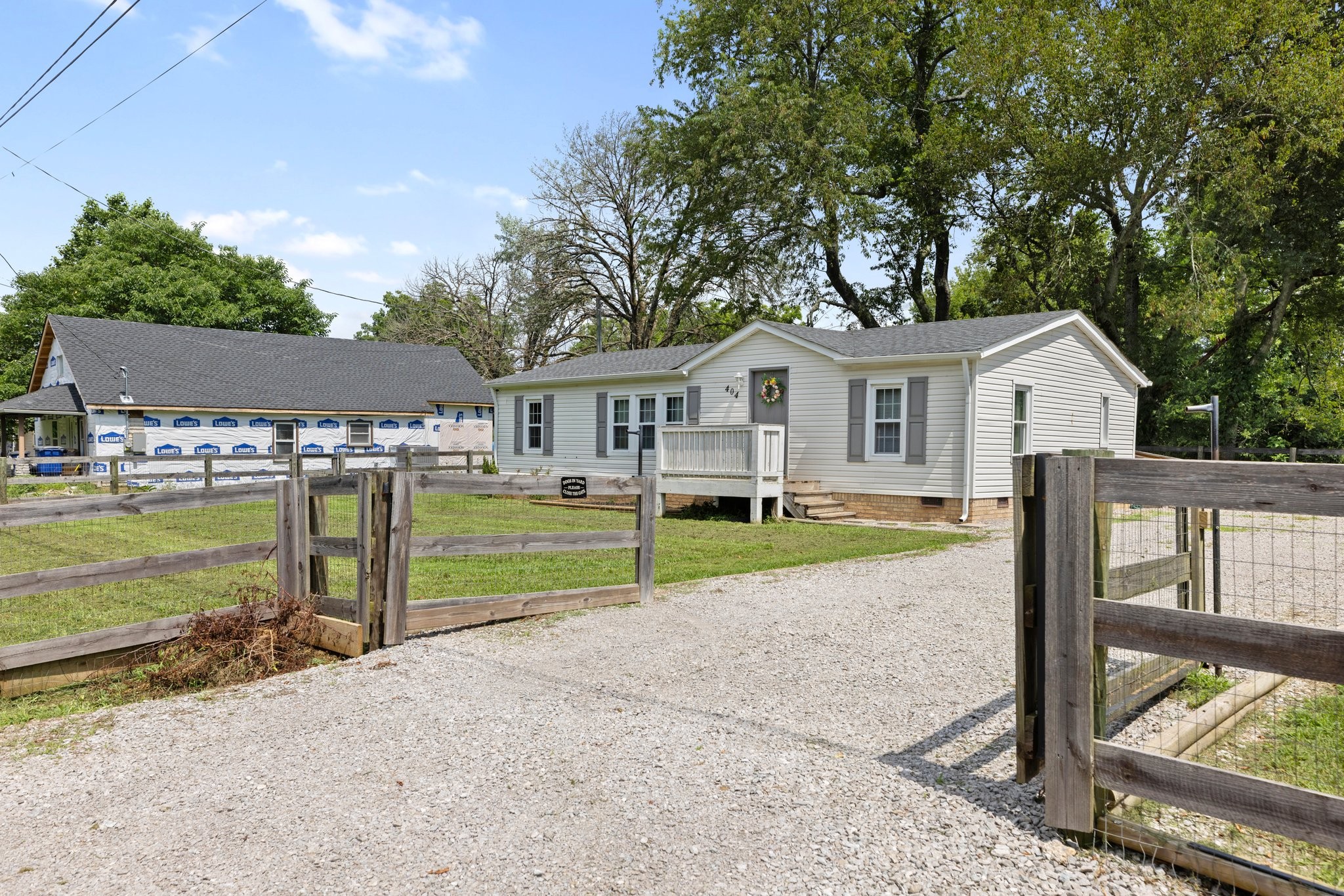 404 Broadview Street Chapel Hill, TN 37034 - Photo 18 of 21 a view of a white house next to a yard with wooden fence