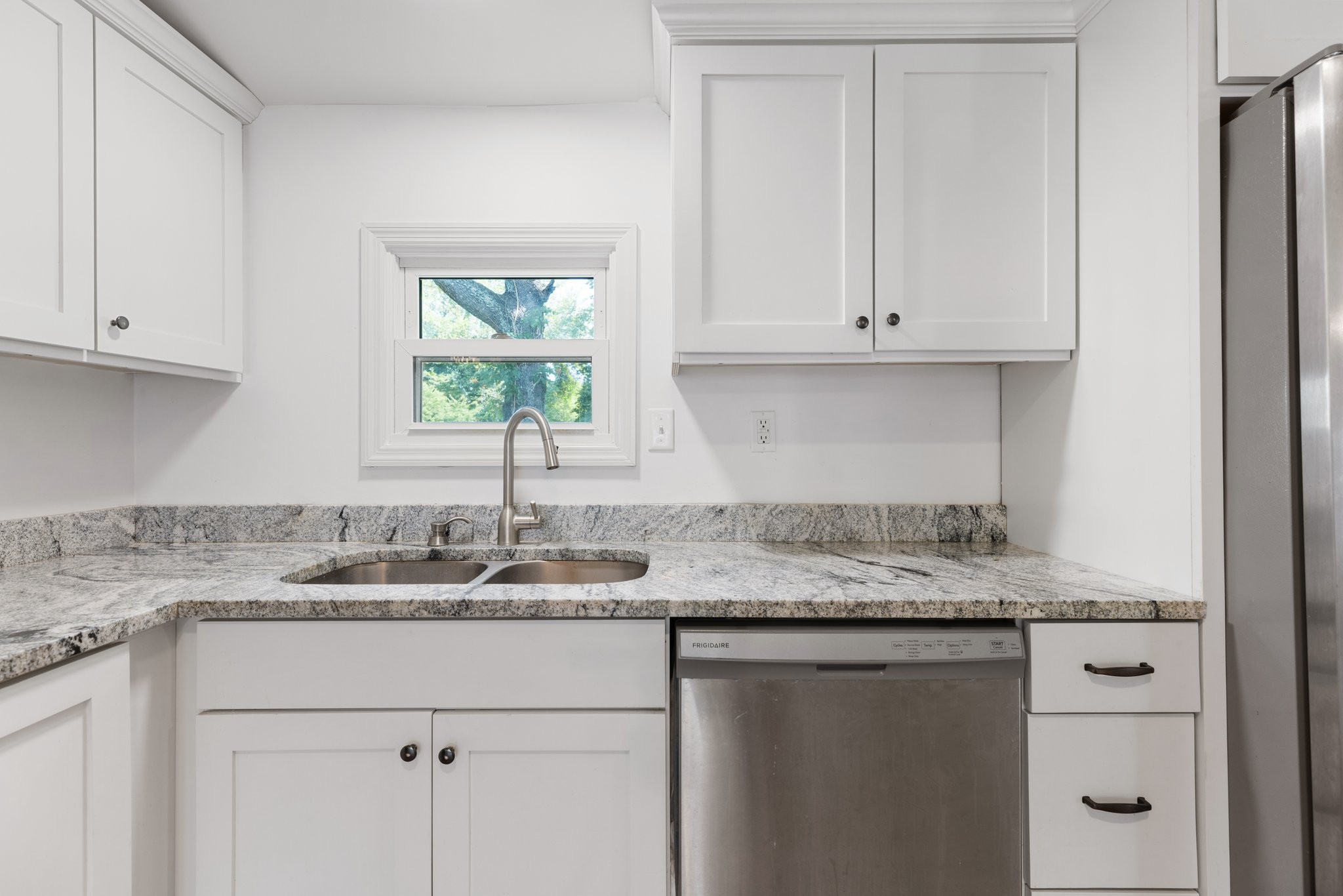 404 Broadview Street Chapel Hill, TN 37034 - Photo 7 of 21 a kitchen with granite countertop stainless steel appliances white cabinets and a window