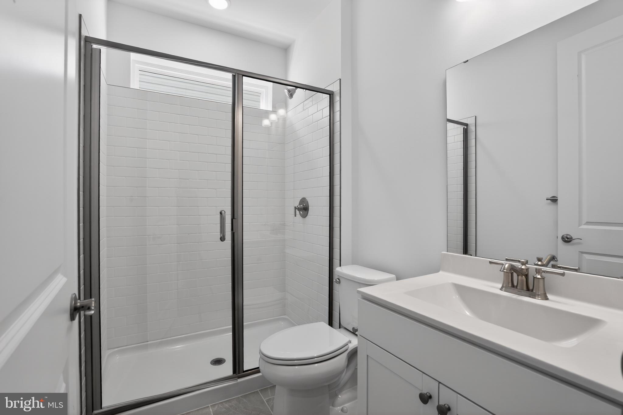 539 Warbler Way Chester, MD 21619 - Photo 16 of 51 a bathroom with a granite countertop sink toilet and shower