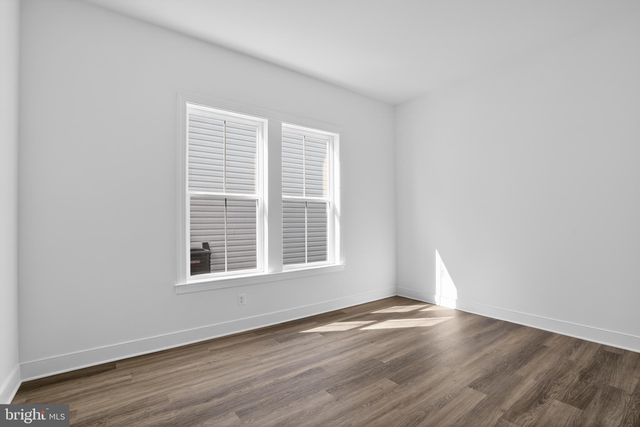 539 Warbler Way Chester, MD 21619 - Photo 22 of 51 a view of an empty room with wooden floor and a window