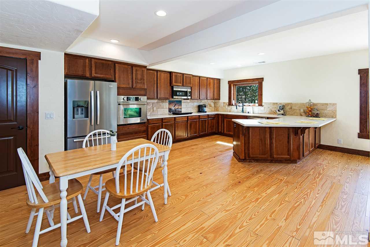15000 North Red Rock Road Reno, NV 89508 - Photo 22 of 25 a view of a dining room with furniture a kitchen and chandelier