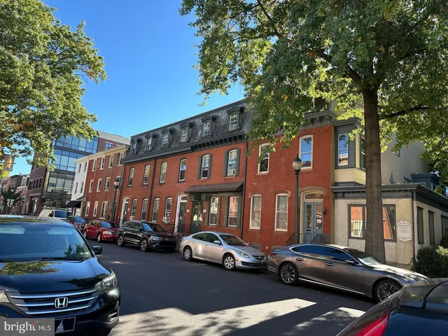 a couple of cars parked in front of a building