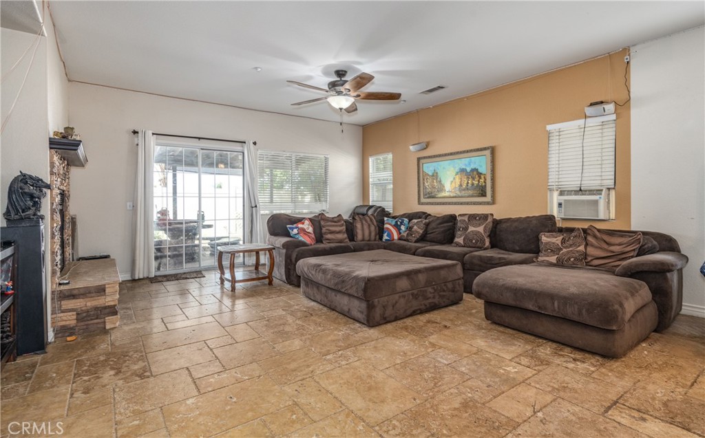 7840 La Cresta Street Highland, CA 92346 - Photo 12 of 47 a living room with couches and a view of kitchen