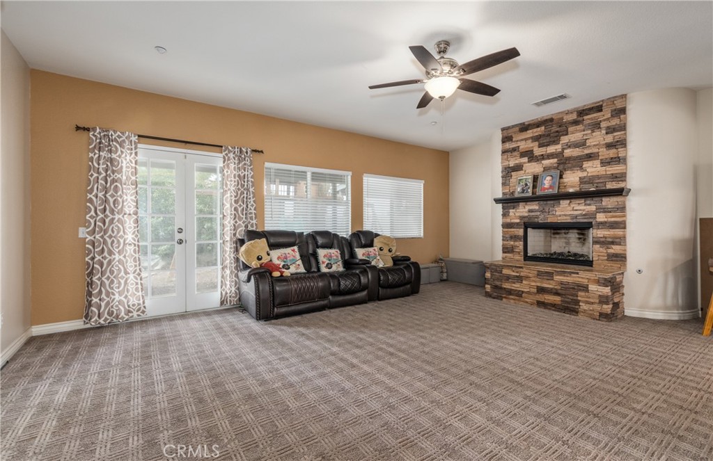 7840 La Cresta Street Highland, CA 92346 - Photo 10 of 47 a living room with furniture and a large window with wooden floor