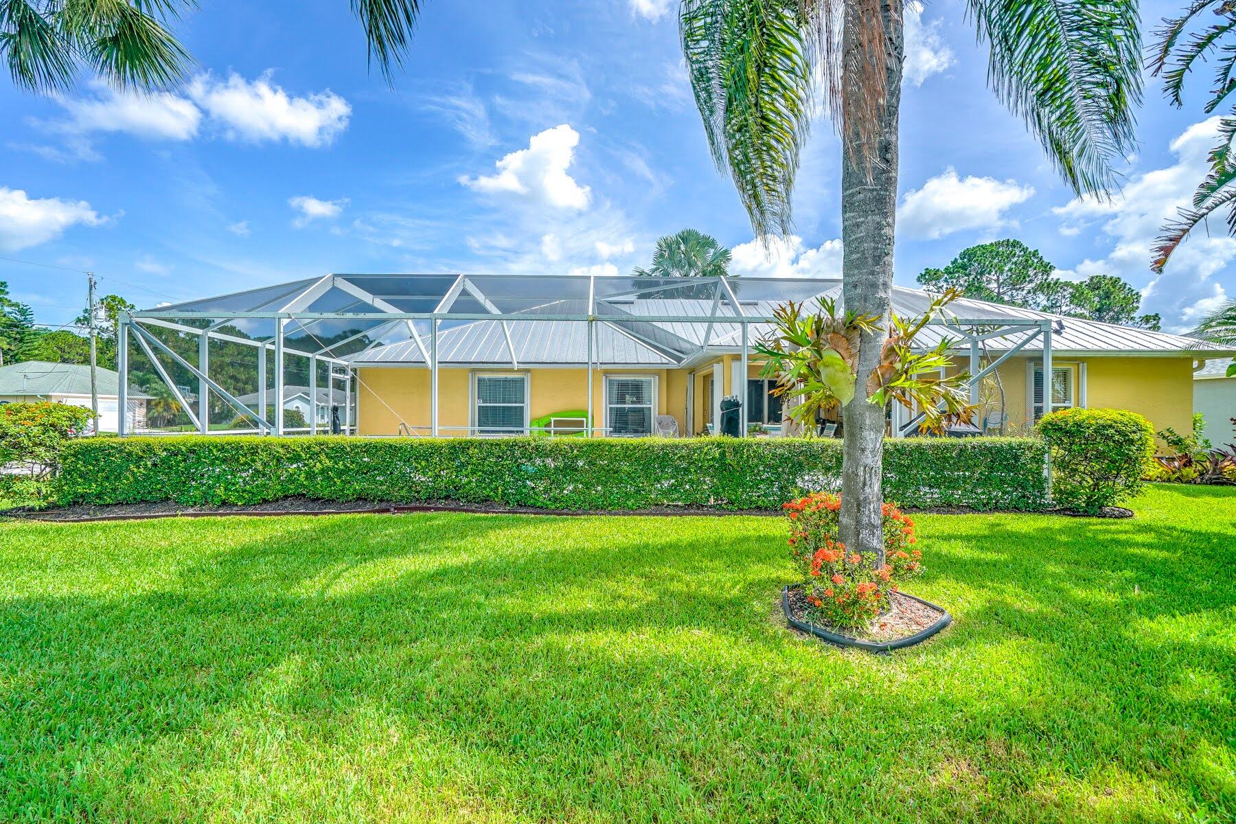 1829 Southwest Hickock Terrace Port St. Lucie, FL 34953 - Photo 12 of 62 a front view of a house with a yard