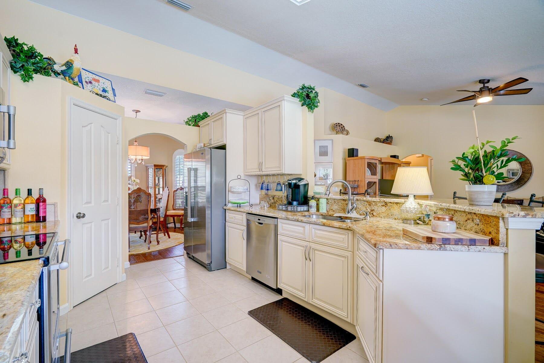 1829 Southwest Hickock Terrace Port St. Lucie, FL 34953 - Photo 29 of 62 a kitchen with a sink a stove cabinets and counter space