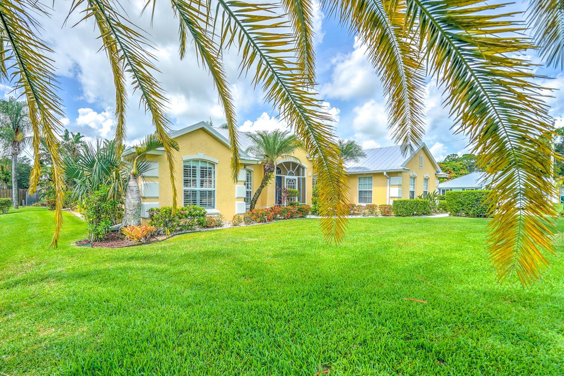 1829 Southwest Hickock Terrace Port St. Lucie, FL 34953 - Photo 3 of 62 a view of a big yard with palm trees