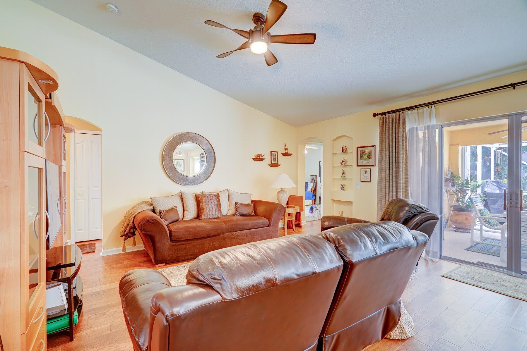 1829 Southwest Hickock Terrace Port St. Lucie, FL 34953 - Photo 35 of 62 a living room with furniture a large window and a chandelier