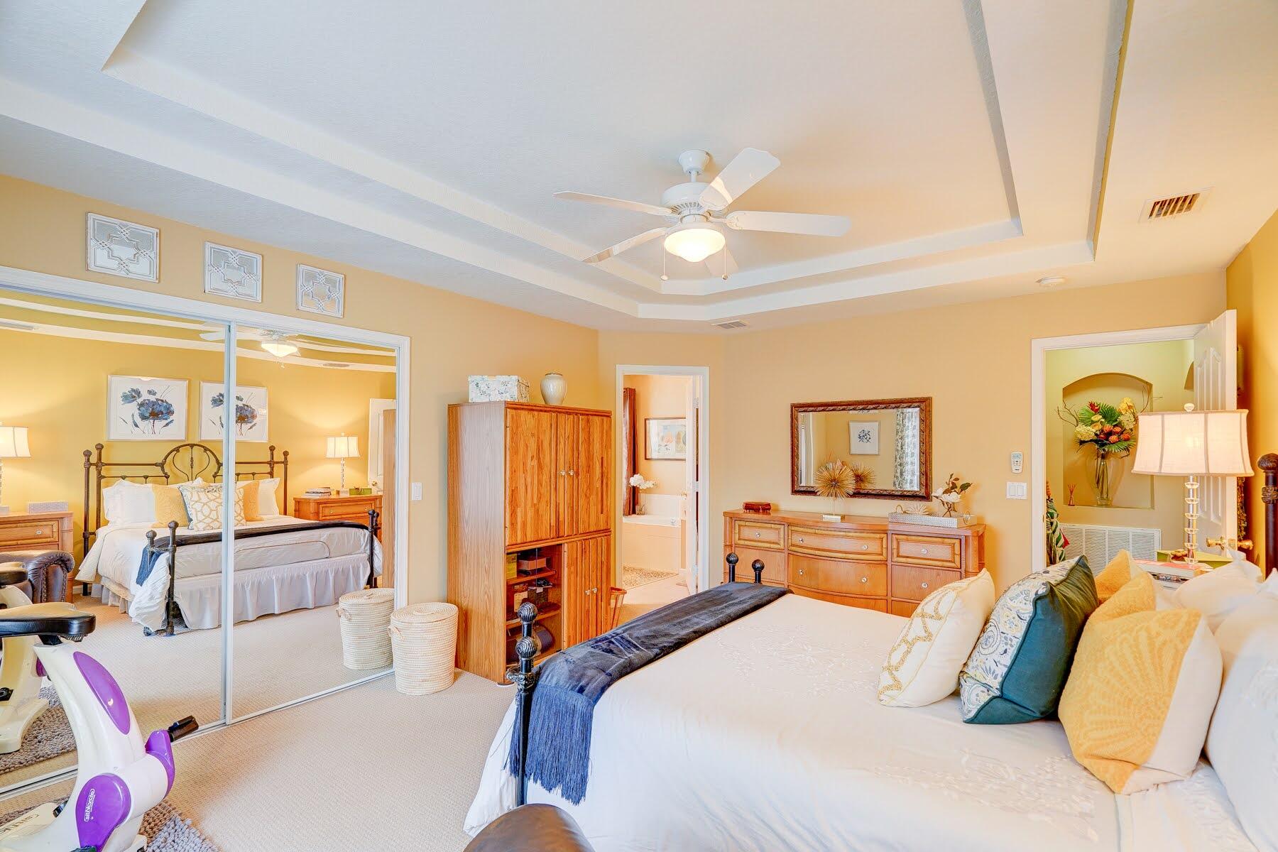 1829 Southwest Hickock Terrace Port St. Lucie, FL 34953 - Photo 41 of 62 a bedroom with a large bed and a chandelier