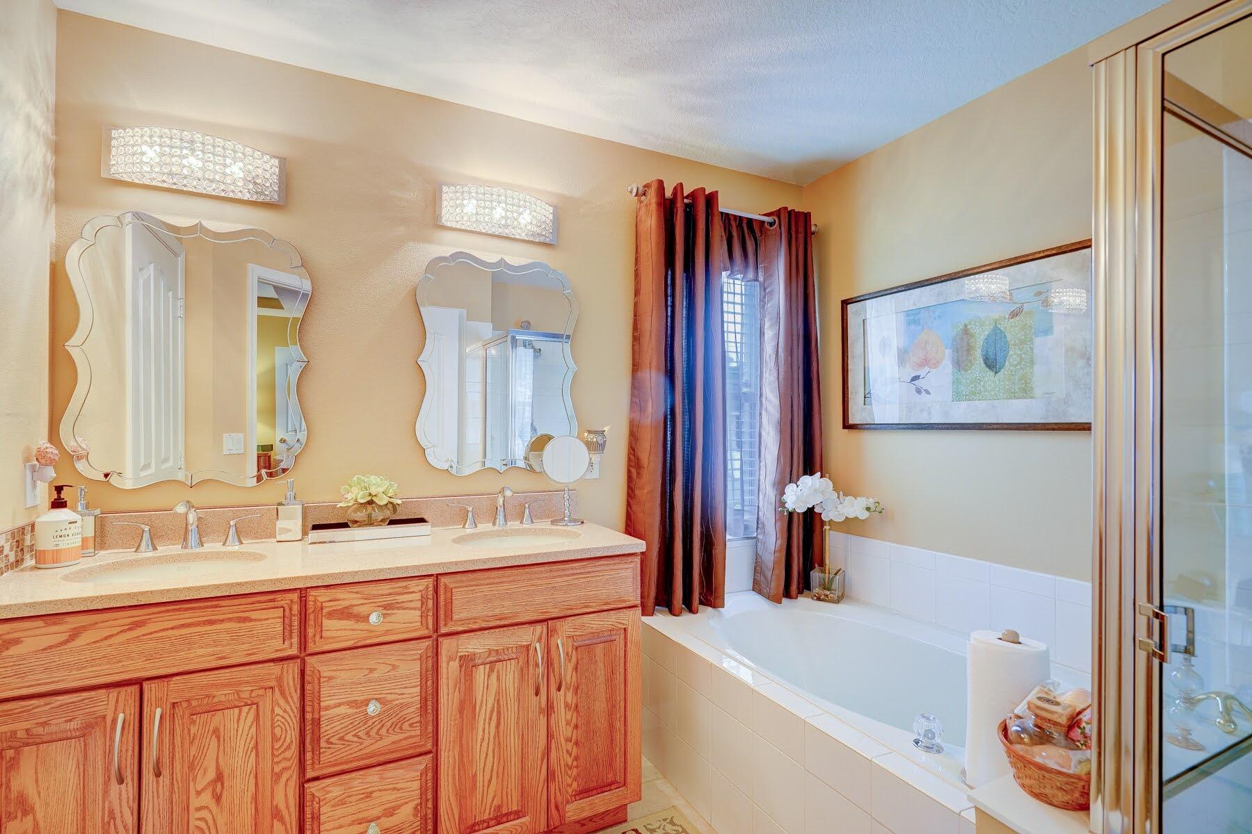 1829 Southwest Hickock Terrace Port St. Lucie, FL 34953 - Photo 42 of 62 a bathroom with a bathtub a sink and a mirror