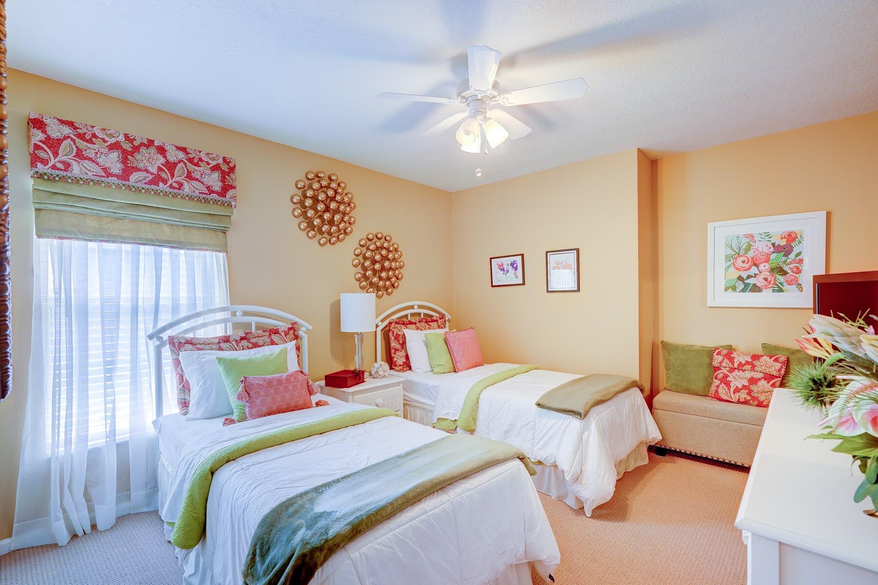 1829 Southwest Hickock Terrace Port St. Lucie, FL 34953 - Photo 45 of 62 a bedroom with two beds and a chandelier