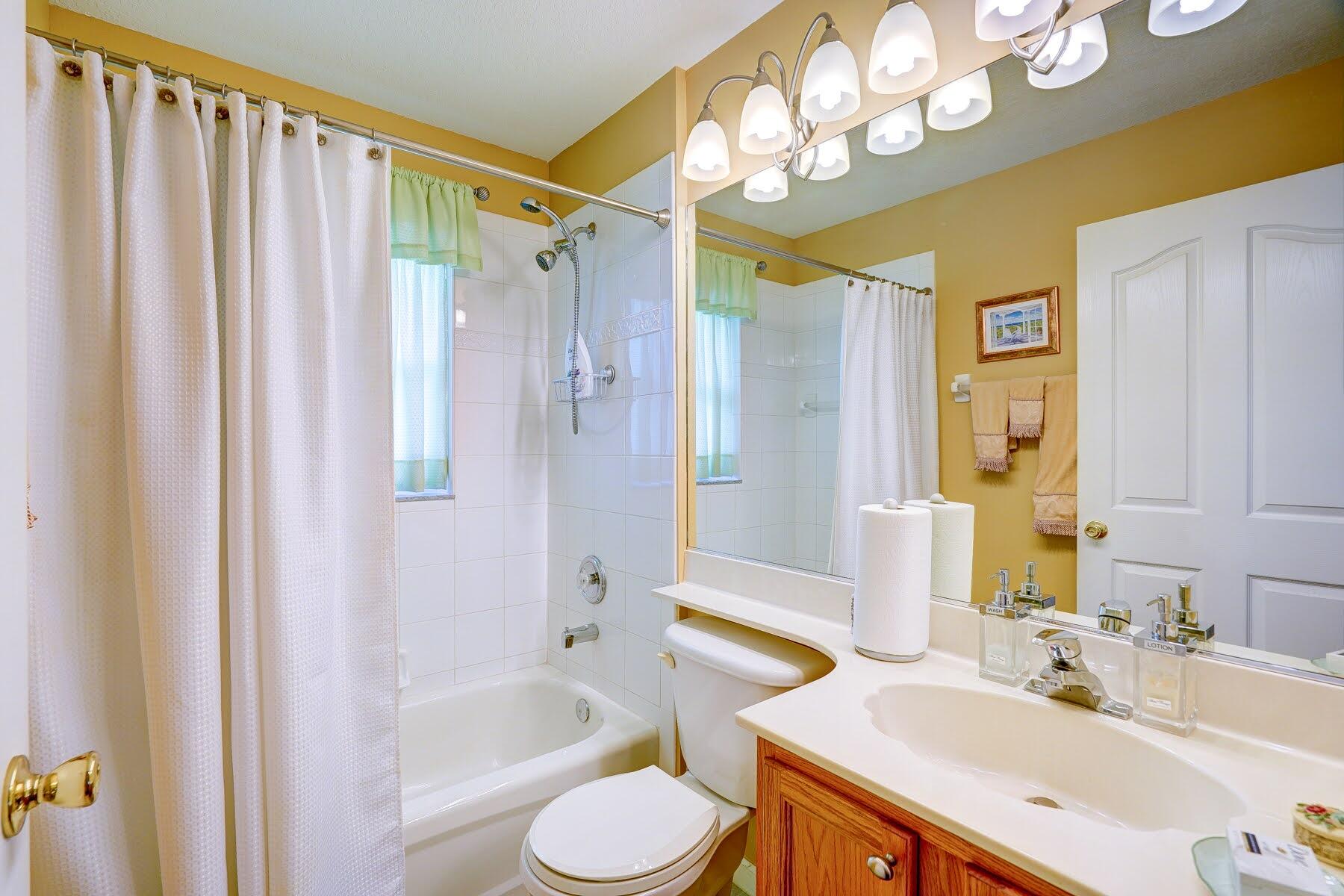1829 Southwest Hickock Terrace Port St. Lucie, FL 34953 - Photo 48 of 62 a bathroom with a sink vanity mirror and toilet