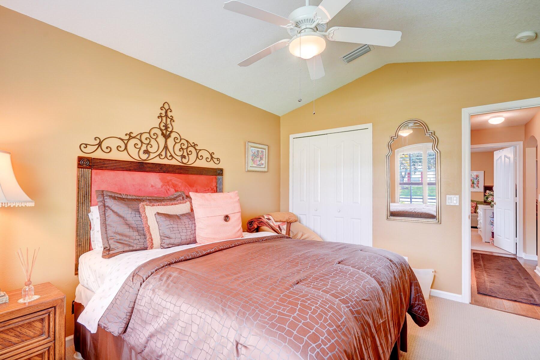 1829 Southwest Hickock Terrace Port St. Lucie, FL 34953 - Photo 51 of 62 a bedroom with a bed and a chandelier