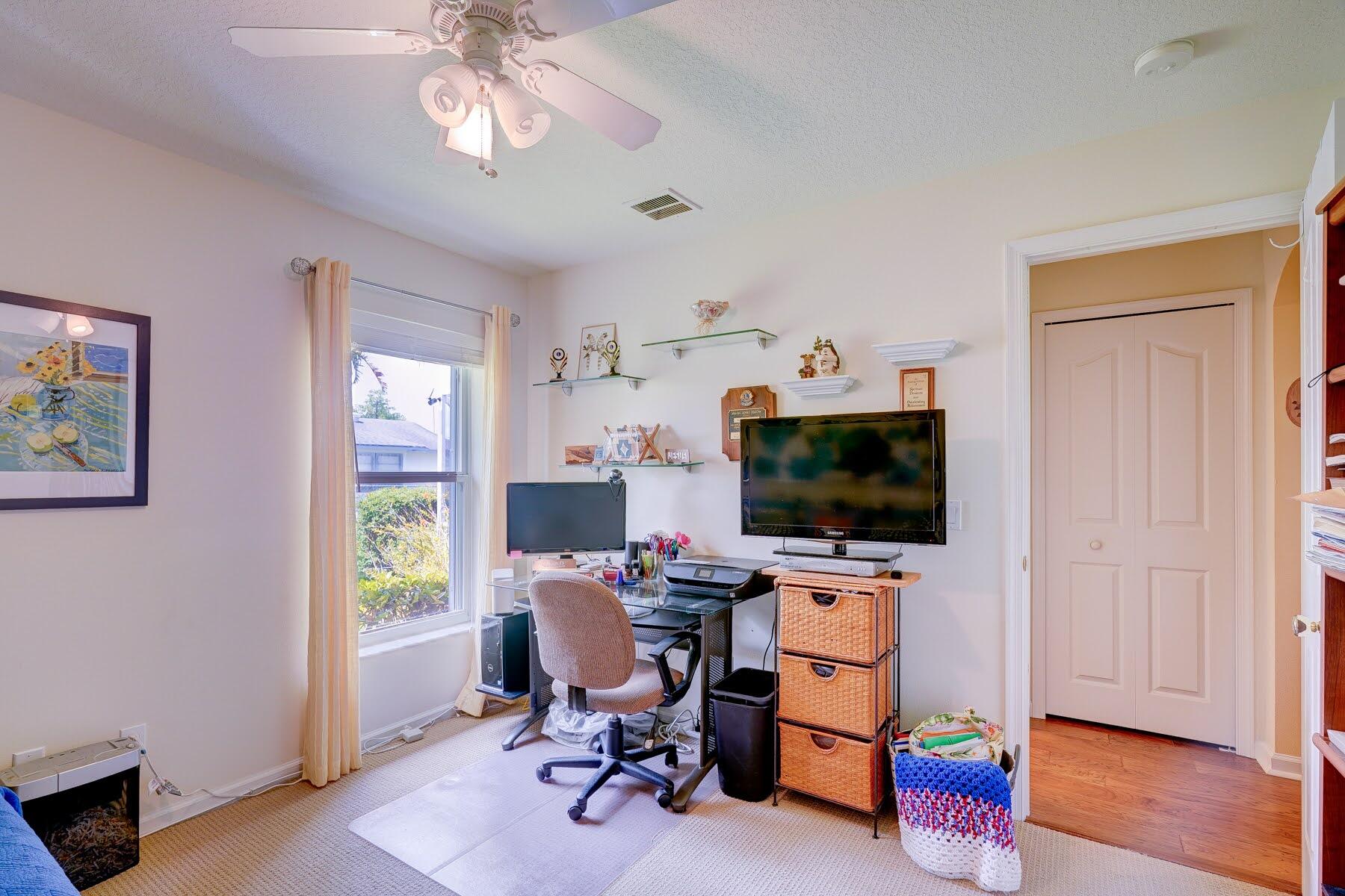 1829 Southwest Hickock Terrace Port St. Lucie, FL 34953 - Photo 54 of 62 a view of a workspace with furniture and a window