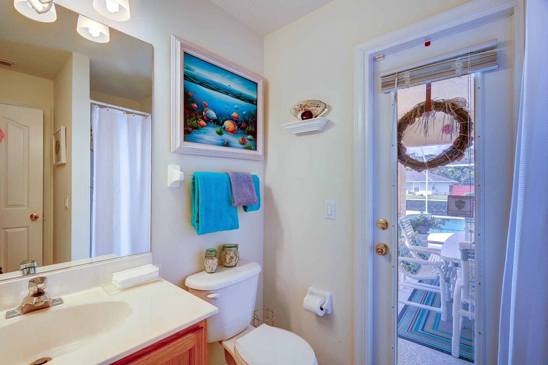 1829 Southwest Hickock Terrace Port St. Lucie, FL 34953 - Photo 56 of 62 a bathroom with a sink mirror and toilet