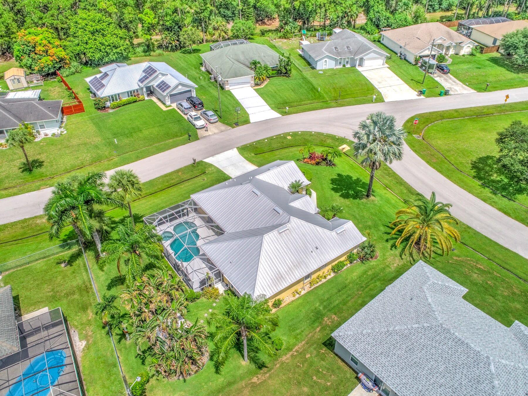 1829 Southwest Hickock Terrace Port St. Lucie, FL 34953 - Photo 62 of 62 an aerial view of residential houses with outdoor space and street view