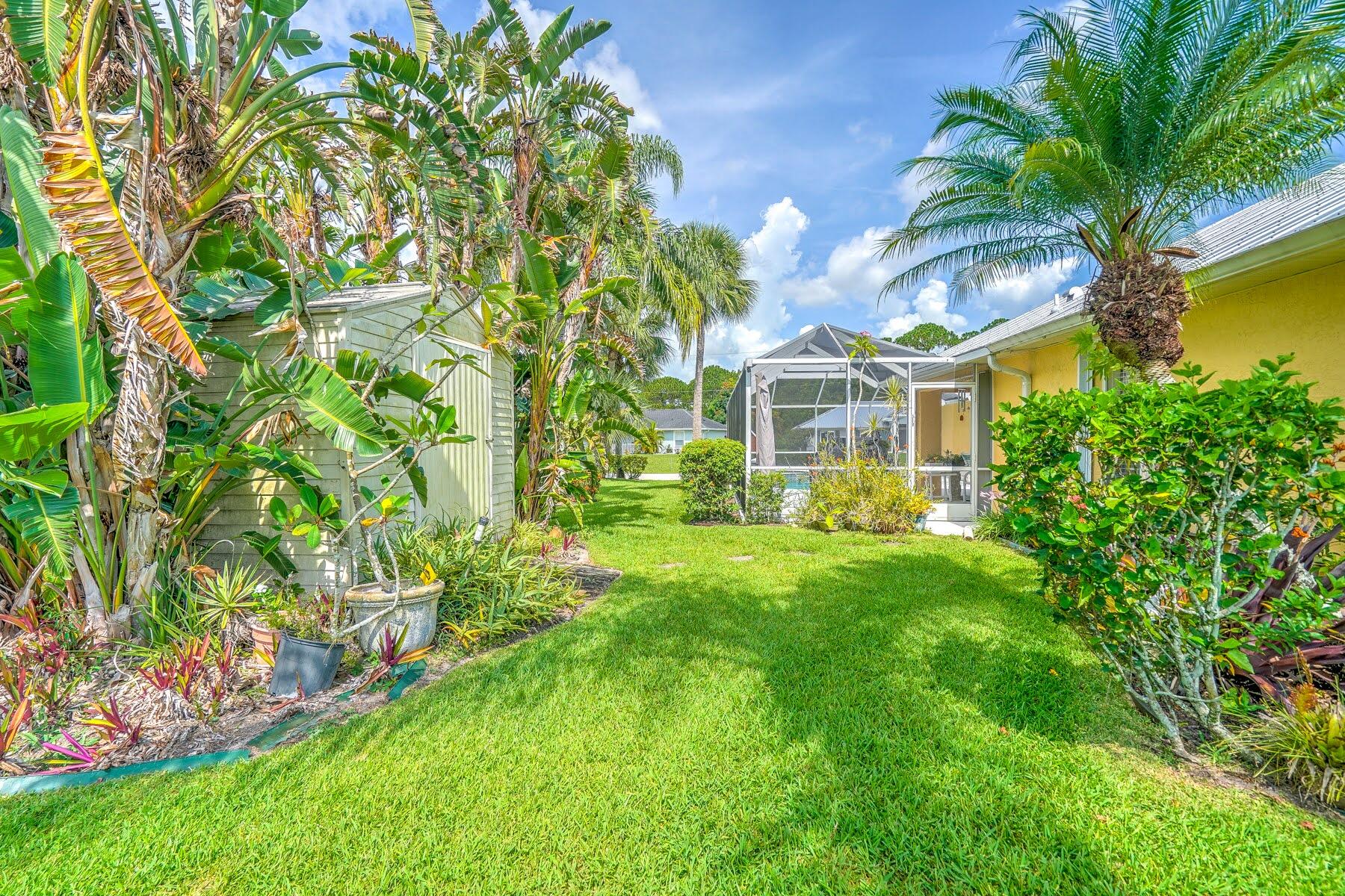 1829 Southwest Hickock Terrace Port St. Lucie, FL 34953 - Photo 7 of 62 a front view of a house with a garden