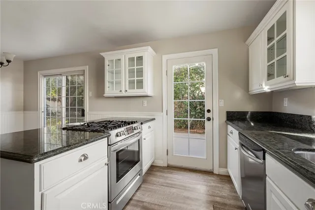 a kitchen with granite countertop a stove and a sink