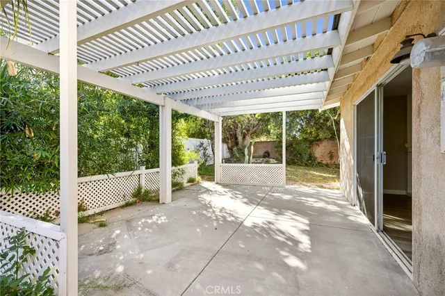 a view of a porch with furniture and floor to ceiling window