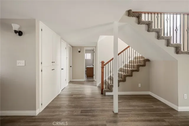 a view of a hallway with wooden floor and entryway