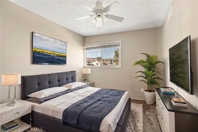 a bedroom with a bed and a flat screen tv