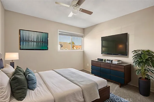 a bedroom with a bed and a flat screen tv
