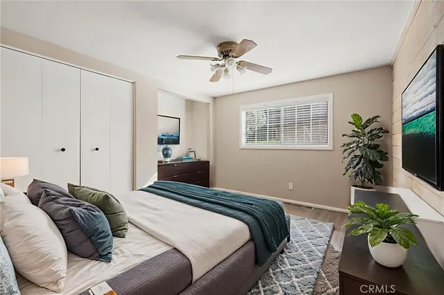 a bedroom with a bed and a potted plant
