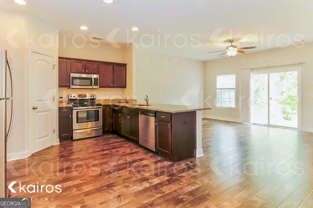 a kitchen with stainless steel appliances granite countertop a stove and a sink