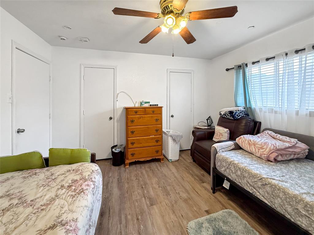 3109 Robin Road Plano, TX 75075 - Photo 15 of 34 a bedroom with a bed and wooden floor