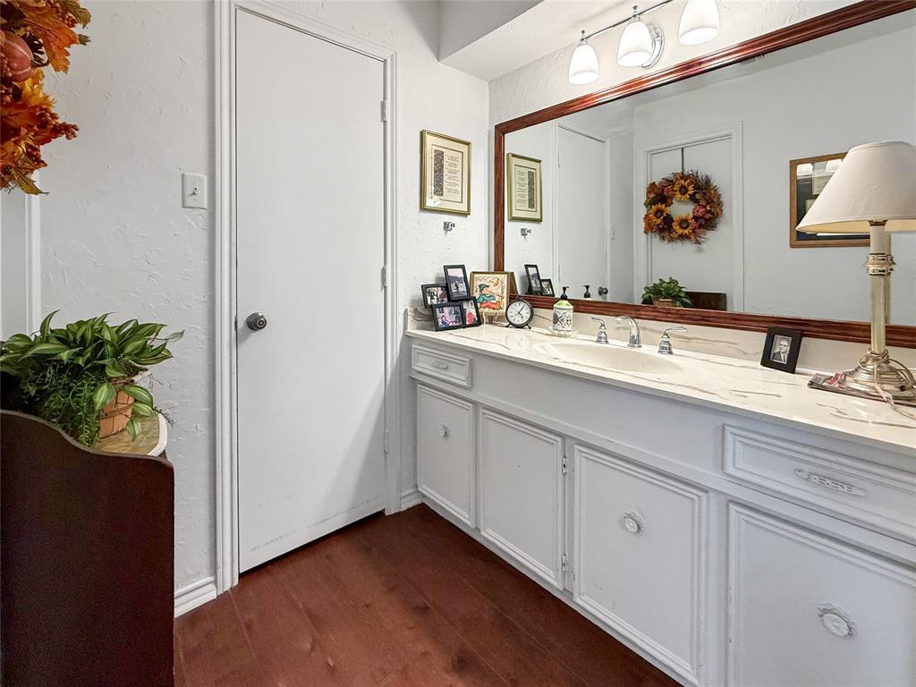 3109 Robin Road Plano, TX 75075 - Photo 18 of 34 a bathroom with a sink a mirror and vanity