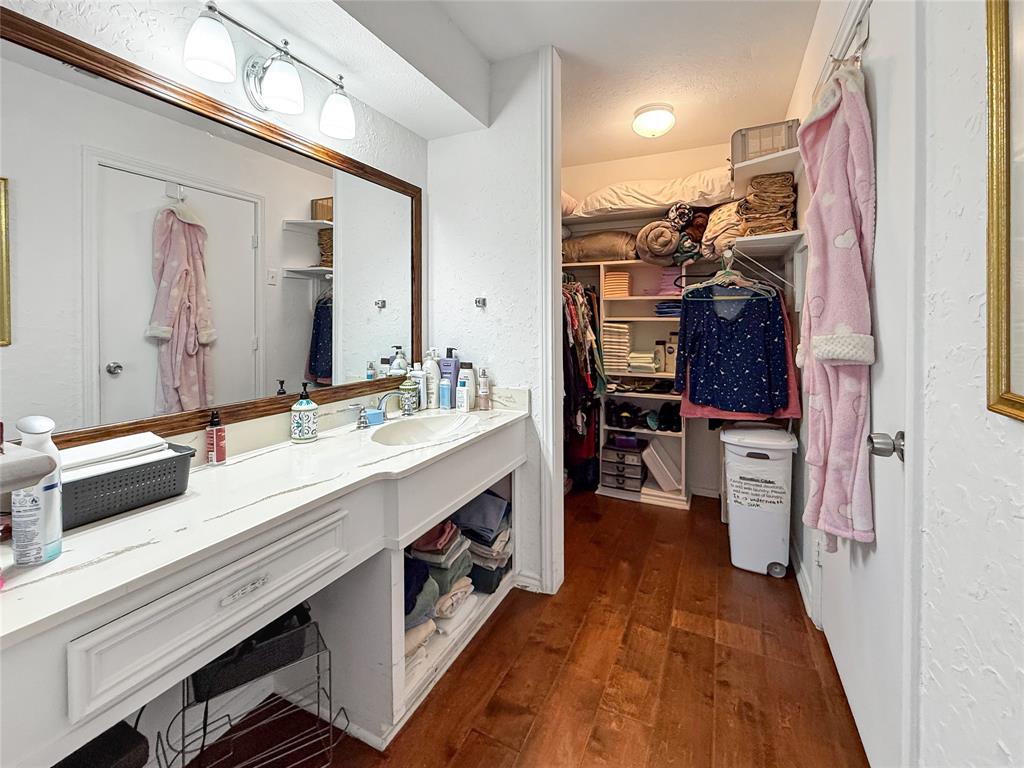 3109 Robin Road Plano, TX 75075 - Photo 19 of 34 a bathroom with a sink a large mirror and a shower