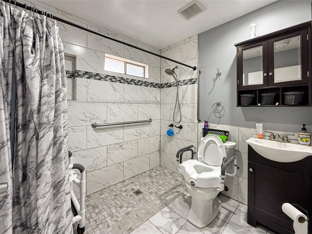 3109 Robin Road Plano, TX 75075 - Photo 22 of 34 a bathroom with a sink toilet and shower