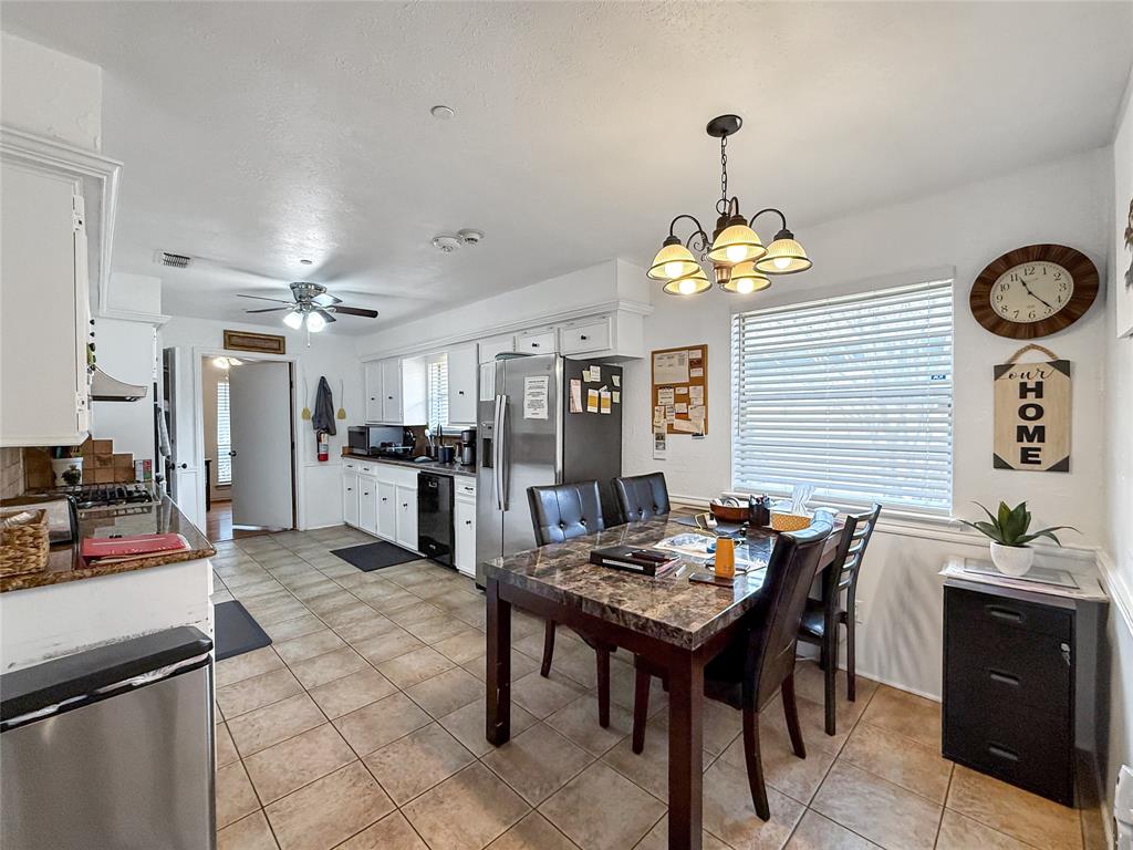 3109 Robin Road Plano, TX 75075 - Photo 9 of 34 a kitchen with a table and chairs in it