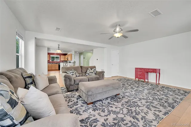 a kitchen with granite countertop white cabinets a window and a sink