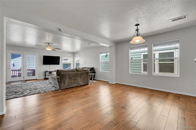 a view of a livingroom with furniture wooden floor and a flat screen tv