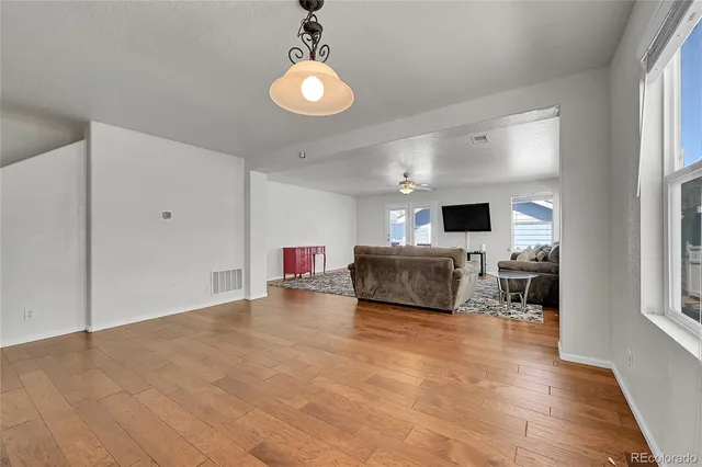 a view of open kitchen with a sink microwave and cabinets