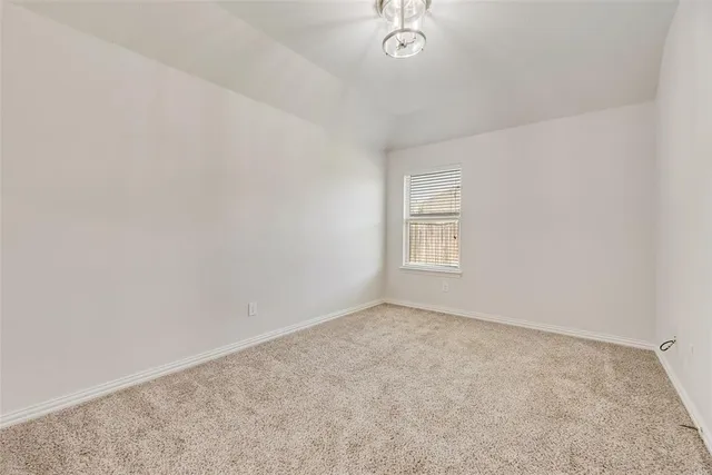 an empty room with a empty space and a window