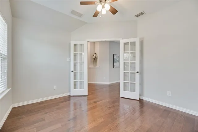 wooden floor in an empty room with a window