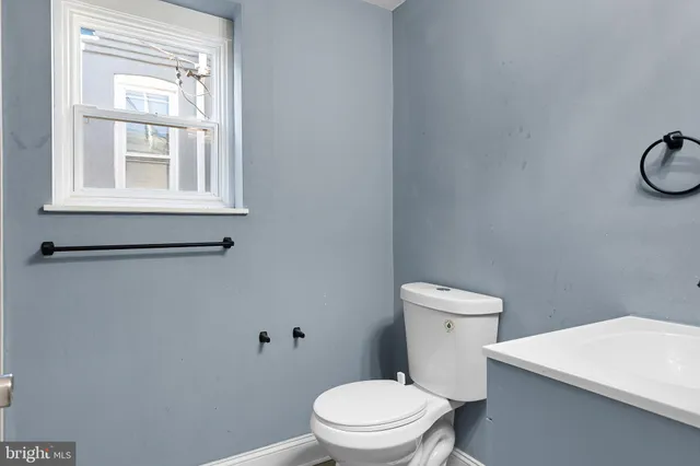 a white toilet sitting next to a bathroom sink