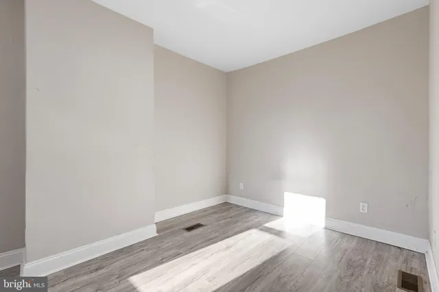 a view of an empty room and wooden floor