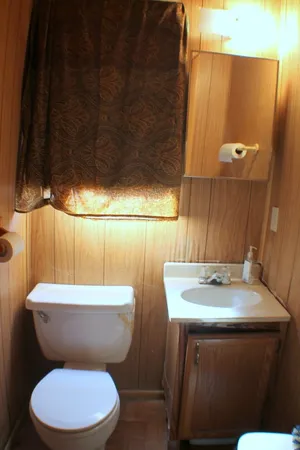 a bedroom with a bed and a chandelier fan