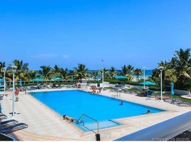 a view of a swimming pool with an outdoor seating